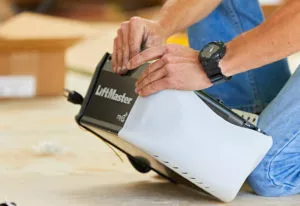 A technician replacing a garage door opener